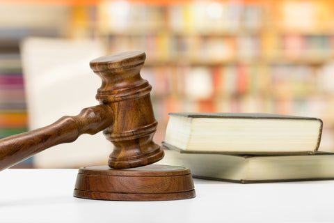 Wooden gavel and books on a wooden table