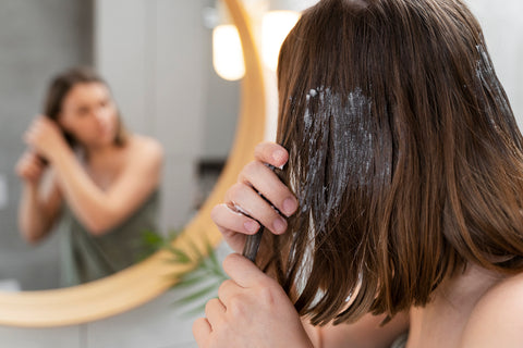 Lady applying blue lotus hair product