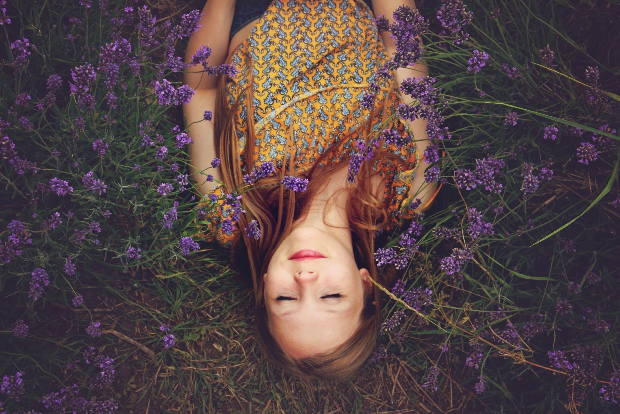 Woman lying down in field with flowers